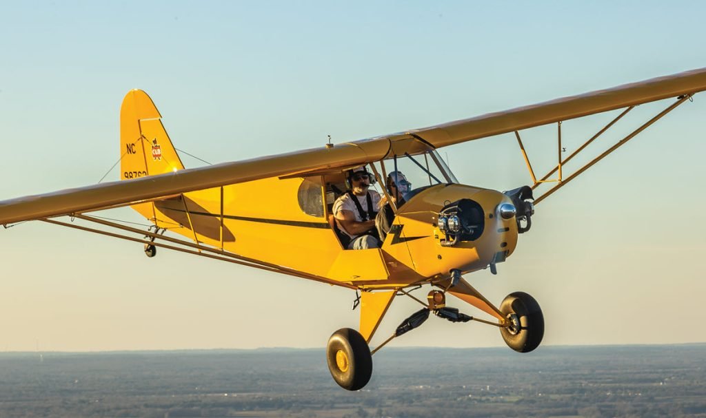 Yellow Piper J-3 Cub taildragger in flight